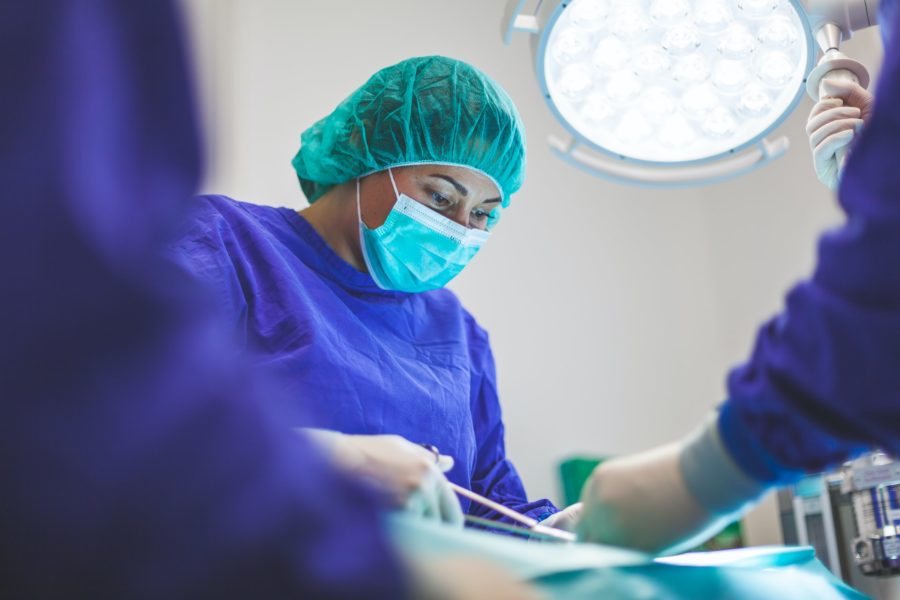 woman performing surgical procedure 